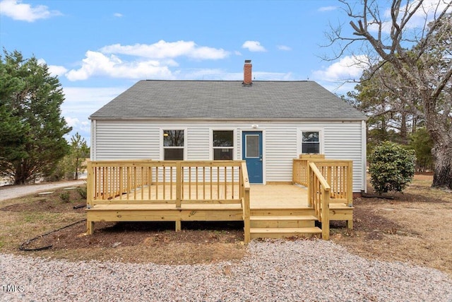 back of property featuring a wooden deck