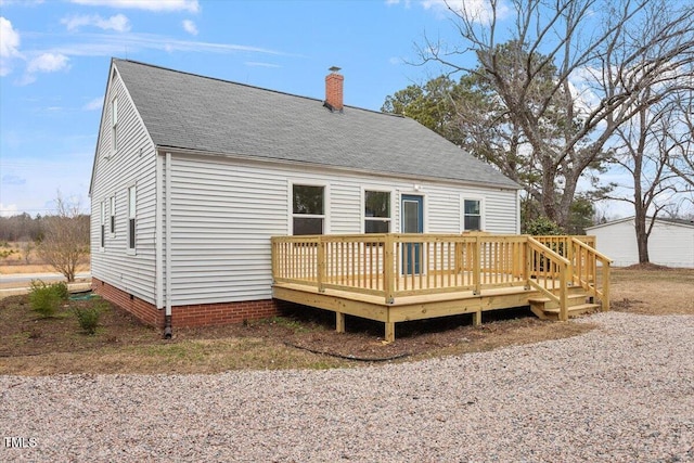 rear view of house featuring a wooden deck