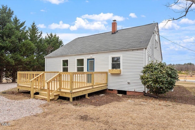 rear view of property featuring a deck