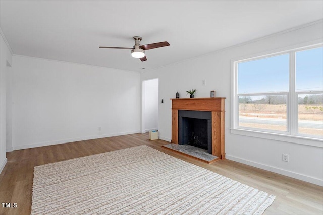 unfurnished living room with ceiling fan and light hardwood / wood-style floors