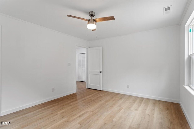 unfurnished room with crown molding, ceiling fan, and light wood-type flooring