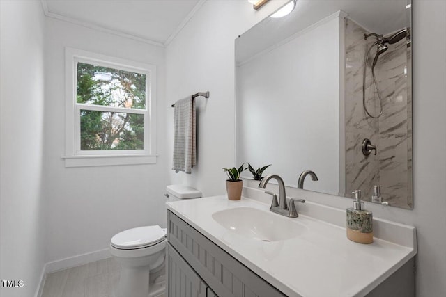 bathroom with walk in shower, ornamental molding, vanity, and toilet