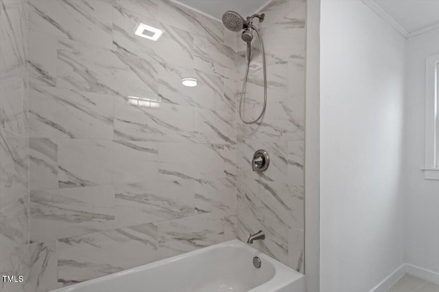 bathroom featuring tiled shower / bath combo and crown molding