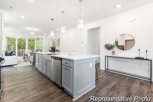 kitchen with sink, gray cabinets, dishwasher, an island with sink, and decorative light fixtures