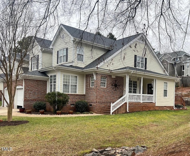 traditional-style home with crawl space, covered porch, brick siding, and a front yard