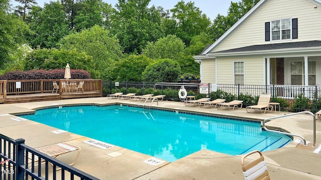 pool with fence and a patio