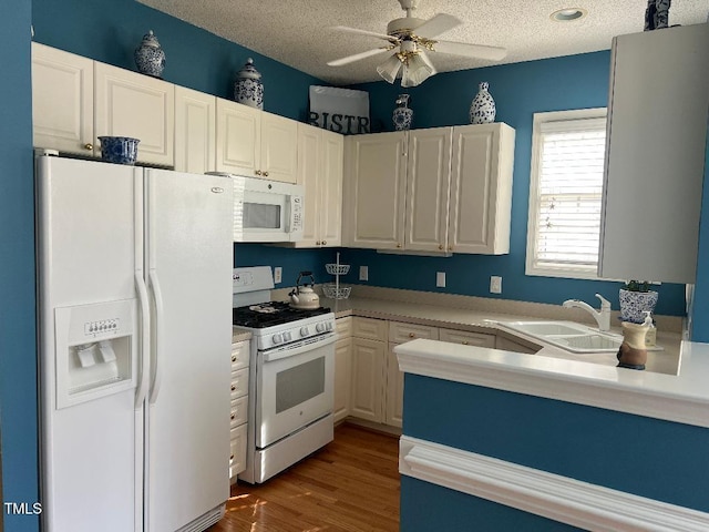 kitchen with white appliances, a ceiling fan, dark wood finished floors, and a textured ceiling