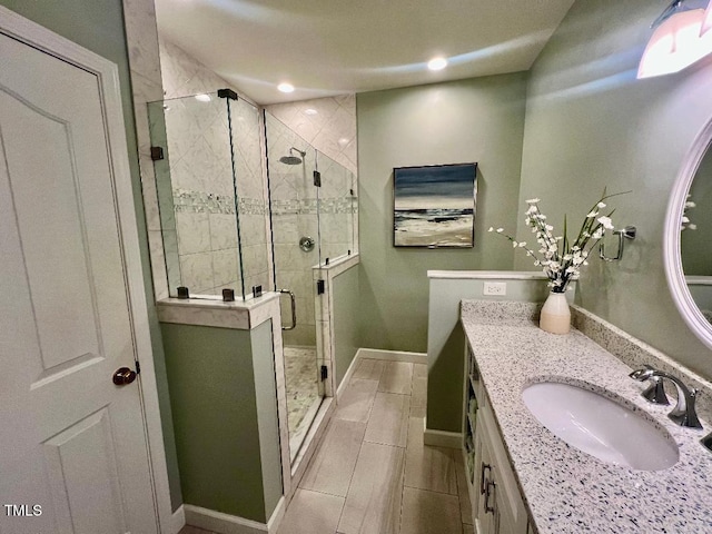 full bathroom with recessed lighting, a shower stall, vanity, and baseboards