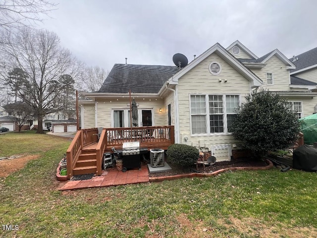 back of property with a garage, a patio, a lawn, and a wooden deck