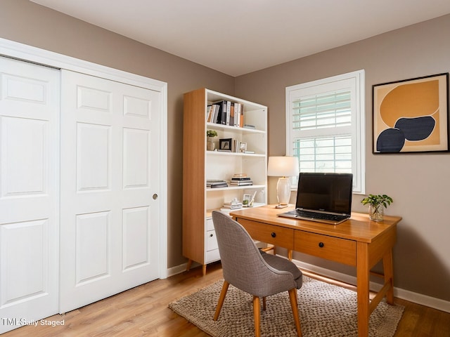home office with light wood finished floors and baseboards