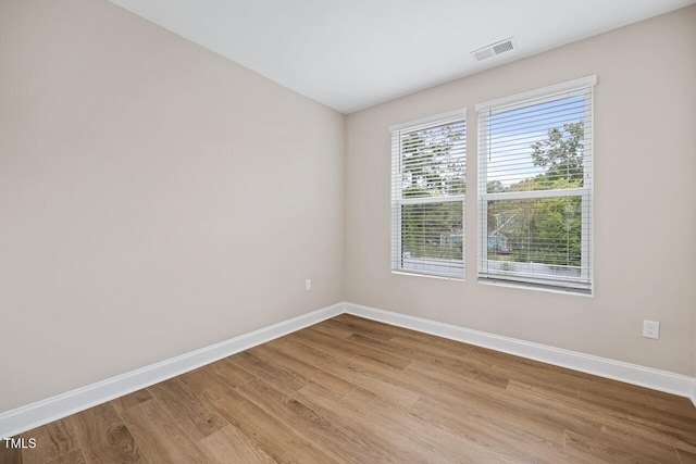 spare room featuring light wood-type flooring