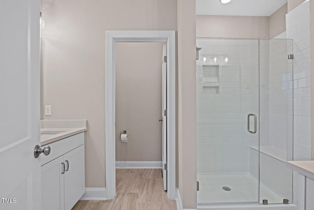 bathroom with walk in shower and vanity