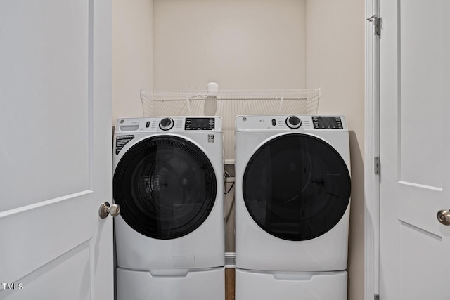 clothes washing area with washer and dryer