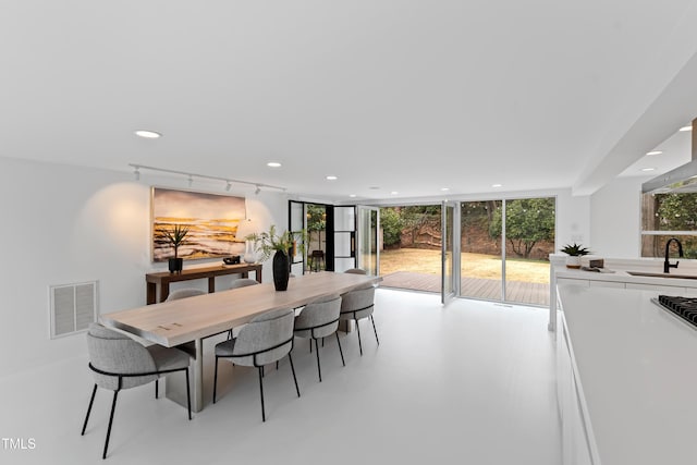 dining room featuring sink and track lighting