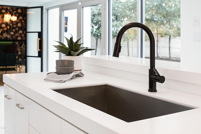 interior details with sink and white cabinets