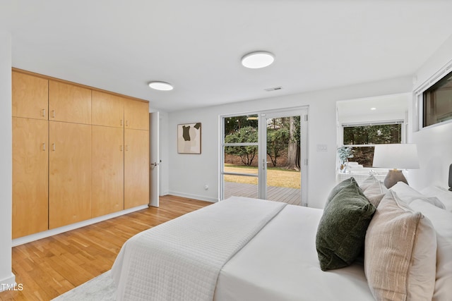 bedroom with access to outside and light hardwood / wood-style floors