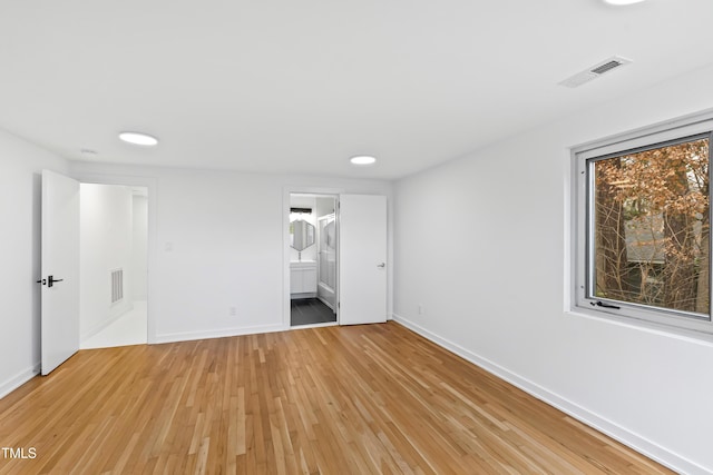 unfurnished bedroom featuring light hardwood / wood-style flooring and ensuite bathroom