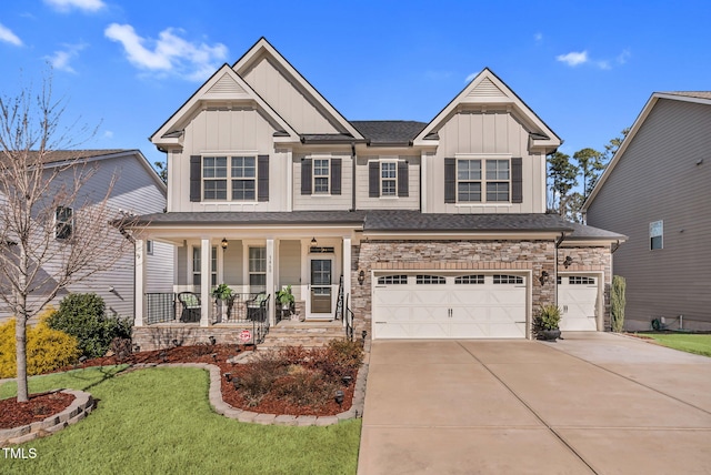 craftsman-style house featuring a garage, concrete driveway, a porch, a front lawn, and board and batten siding