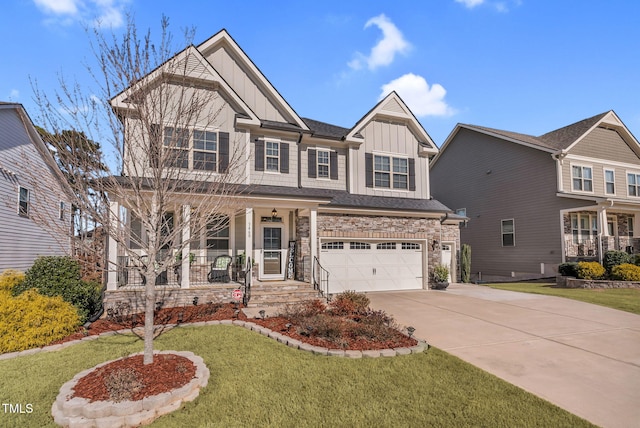 craftsman-style house with a porch, an attached garage, concrete driveway, a front lawn, and board and batten siding