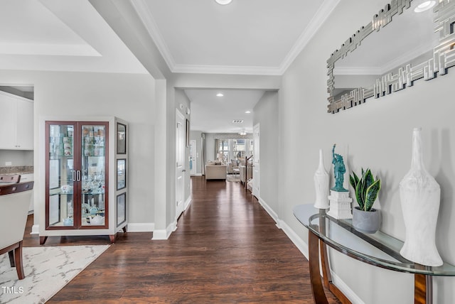 entryway with crown molding, baseboards, wood finished floors, and recessed lighting