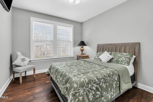 bedroom featuring wood finished floors and baseboards