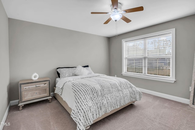 carpeted bedroom featuring ceiling fan and baseboards