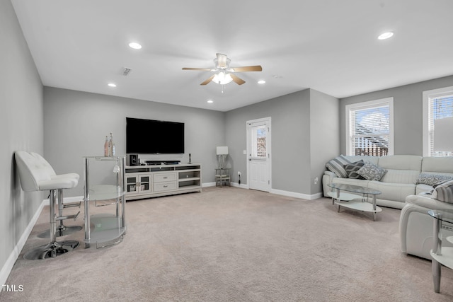 carpeted living area featuring baseboards, visible vents, a ceiling fan, and recessed lighting