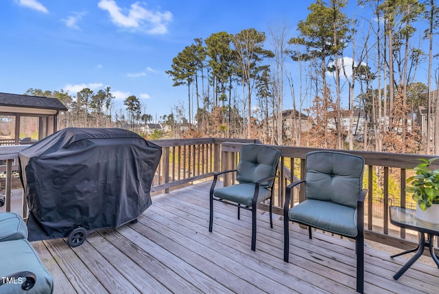 wooden deck featuring area for grilling