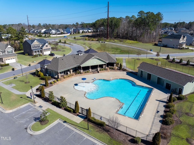 pool featuring a patio area, fence, and a residential view