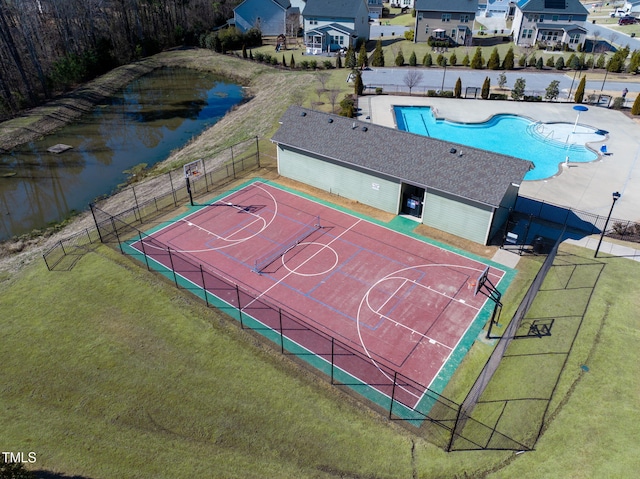 view of sport court featuring community basketball court, fence, and a lawn