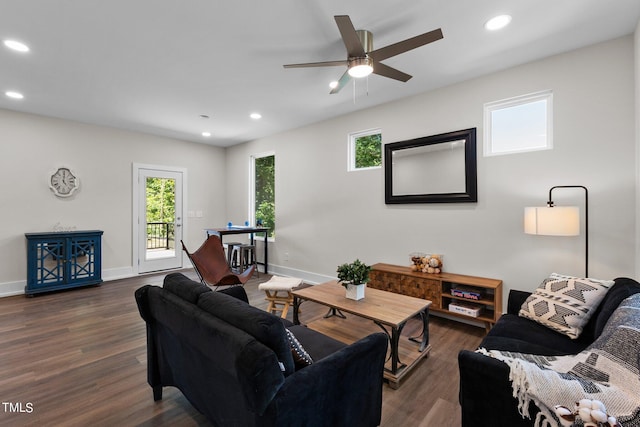 living room with dark hardwood / wood-style floors and ceiling fan