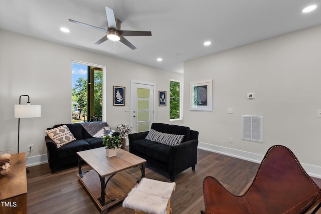 living room with dark wood-type flooring and ceiling fan