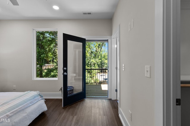 bedroom featuring access to outside and dark hardwood / wood-style floors