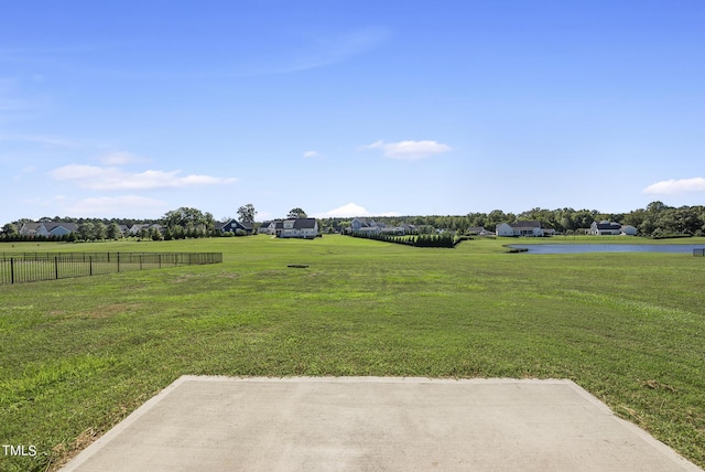 view of yard featuring a water view and fence