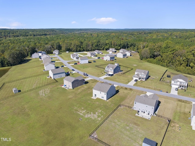 birds eye view of property with a forest view