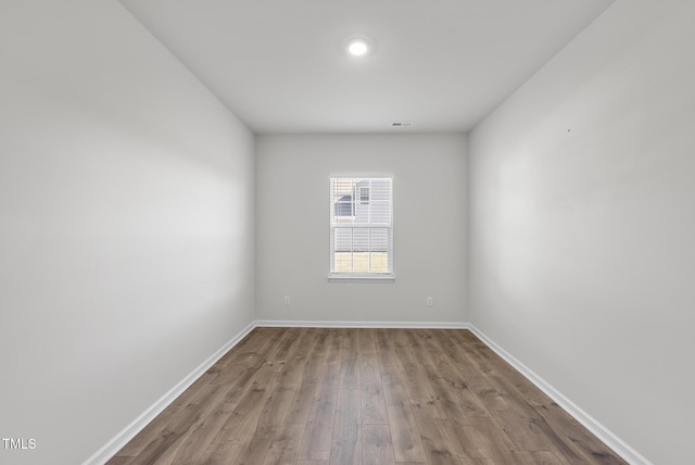 empty room with wood finished floors and baseboards