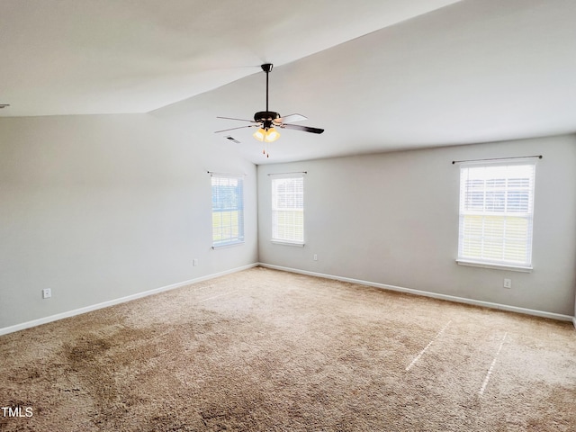 unfurnished room featuring vaulted ceiling, carpet flooring, a ceiling fan, and baseboards