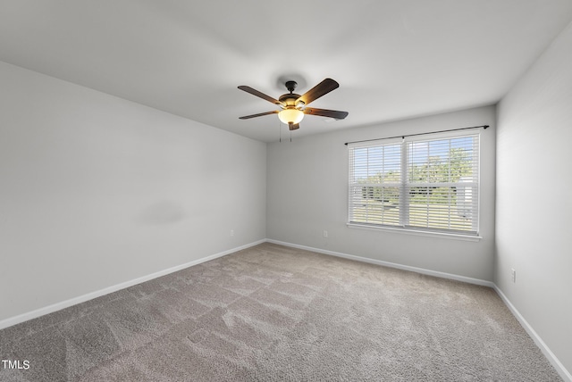 spare room featuring carpet flooring, ceiling fan, and baseboards