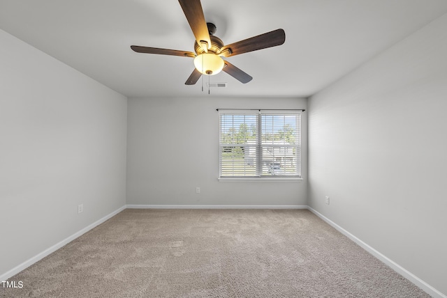 carpeted empty room featuring visible vents, baseboards, and a ceiling fan