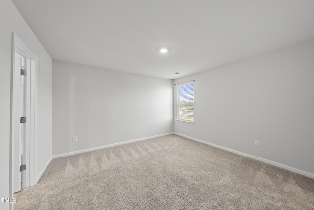 empty room with baseboards and carpet floors