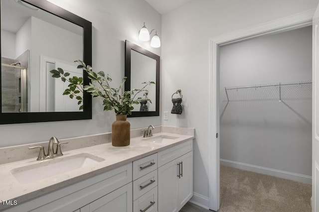 bathroom featuring walk in shower and vanity