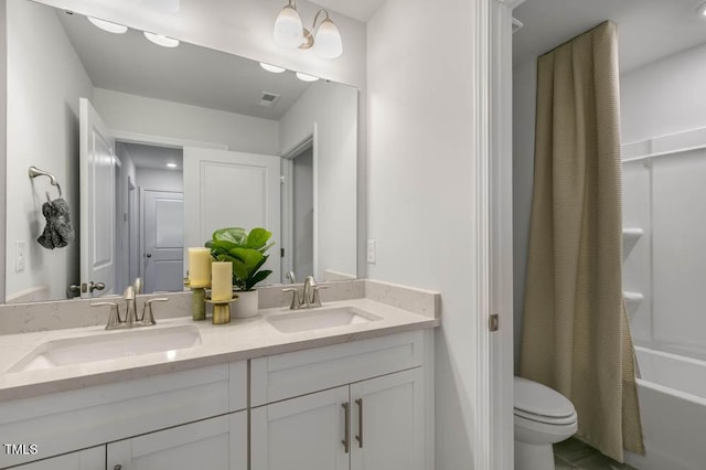 full bathroom featuring vanity, shower / tub combo, and toilet