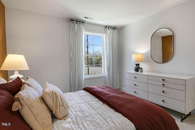 bedroom featuring light carpet