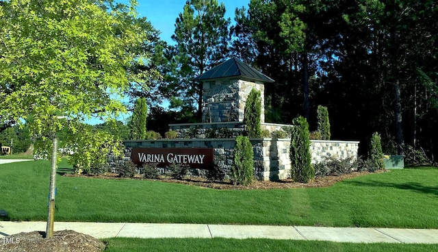 community / neighborhood sign with a lawn