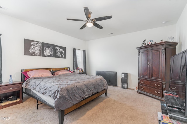 bedroom featuring ceiling fan and light carpet