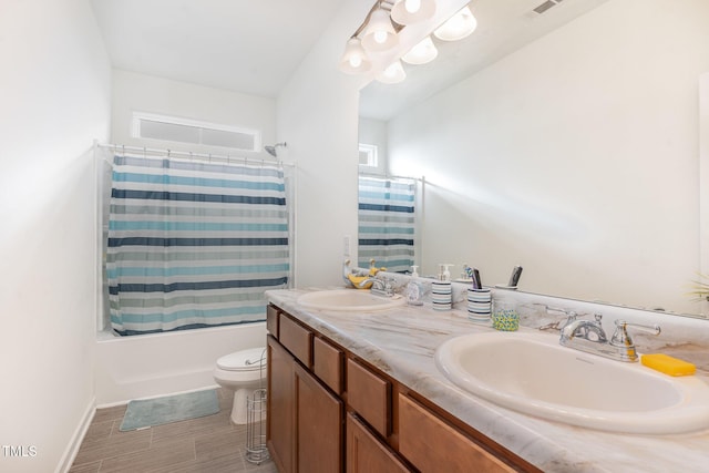 full bathroom with vanity, shower / bath combo, and toilet