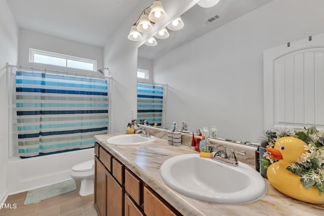 108 Bonnie Girl Ct, Lillington, NC 27546 - bathroom with double vanity, shower / bathtub combination with curtain, visible vents, and a sink