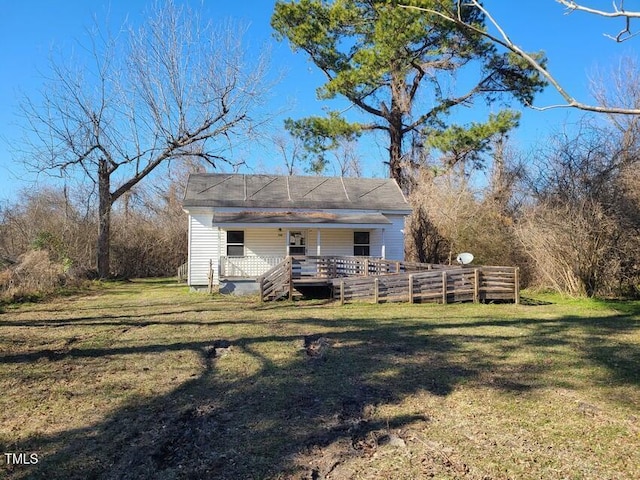 back of house featuring a deck and a lawn