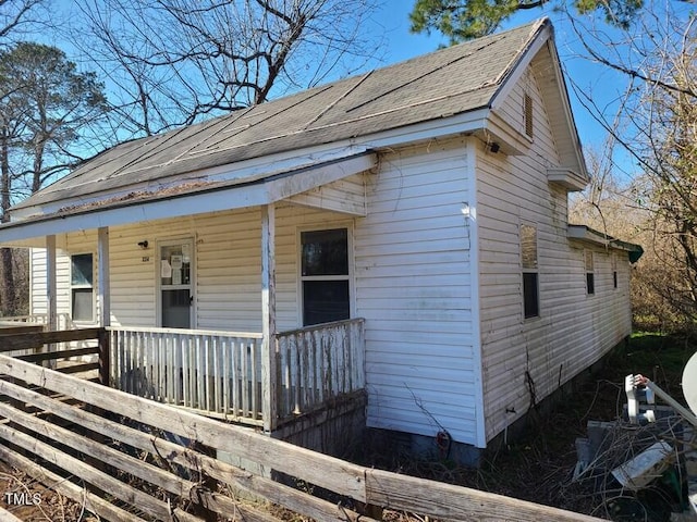 view of side of property with covered porch