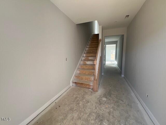 stairway featuring baseboards